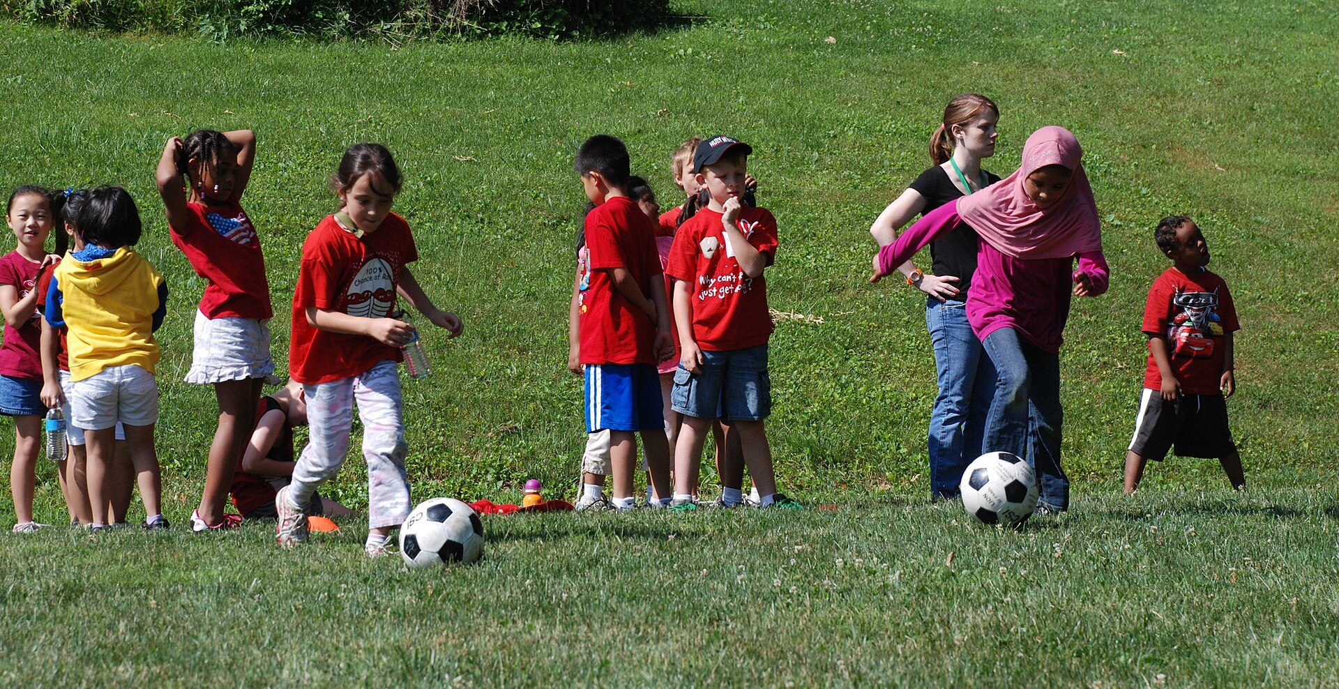 Junior students playing football on the field