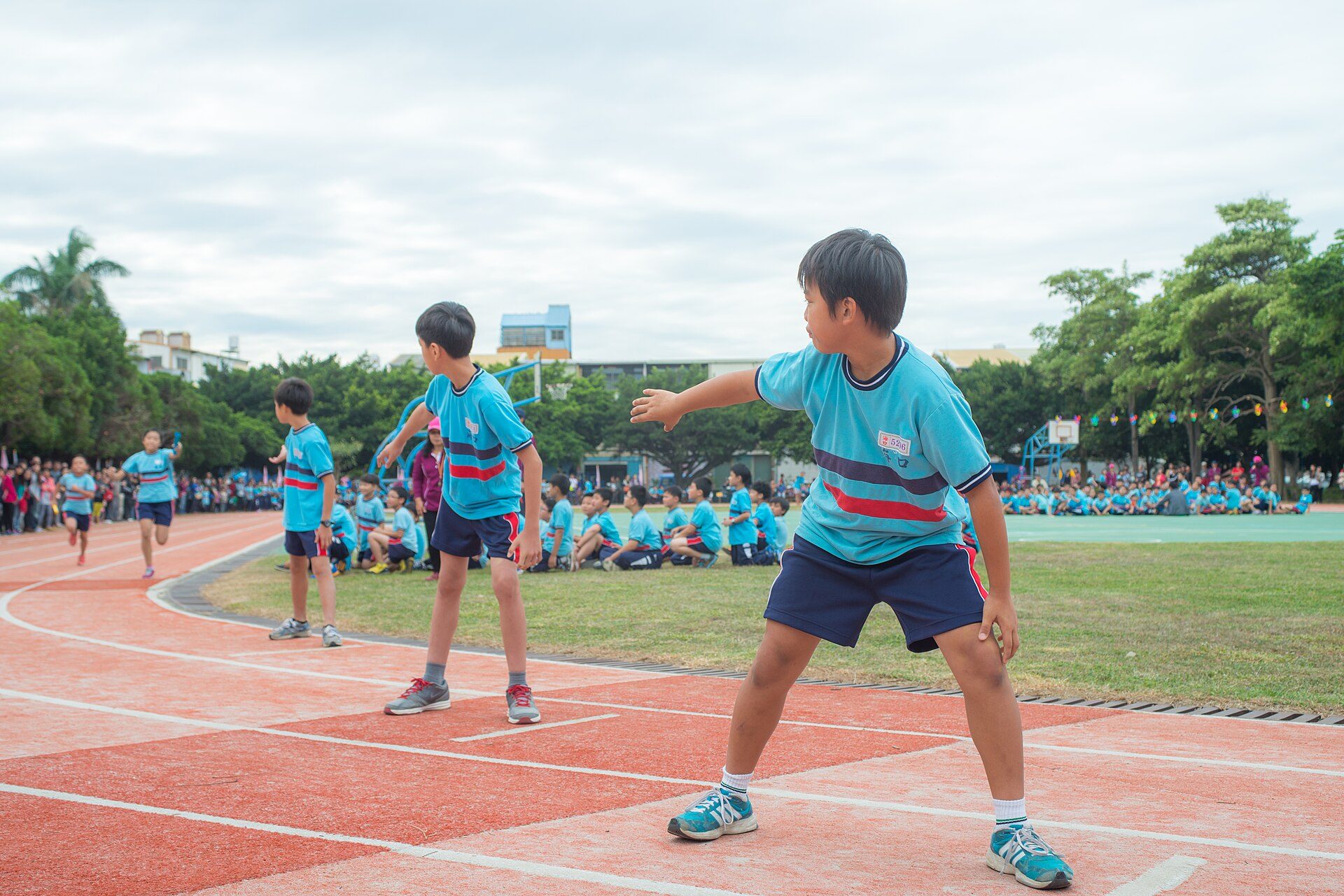 Young athletes sprinting towards the finish line on sports day