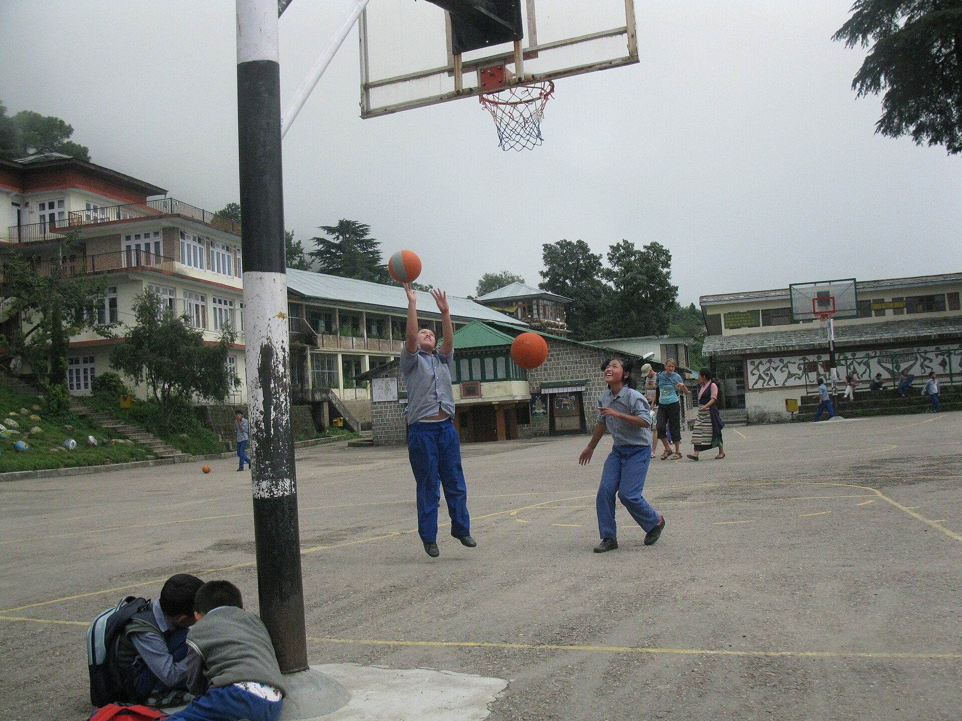 Children playing basketball on the outdoor court